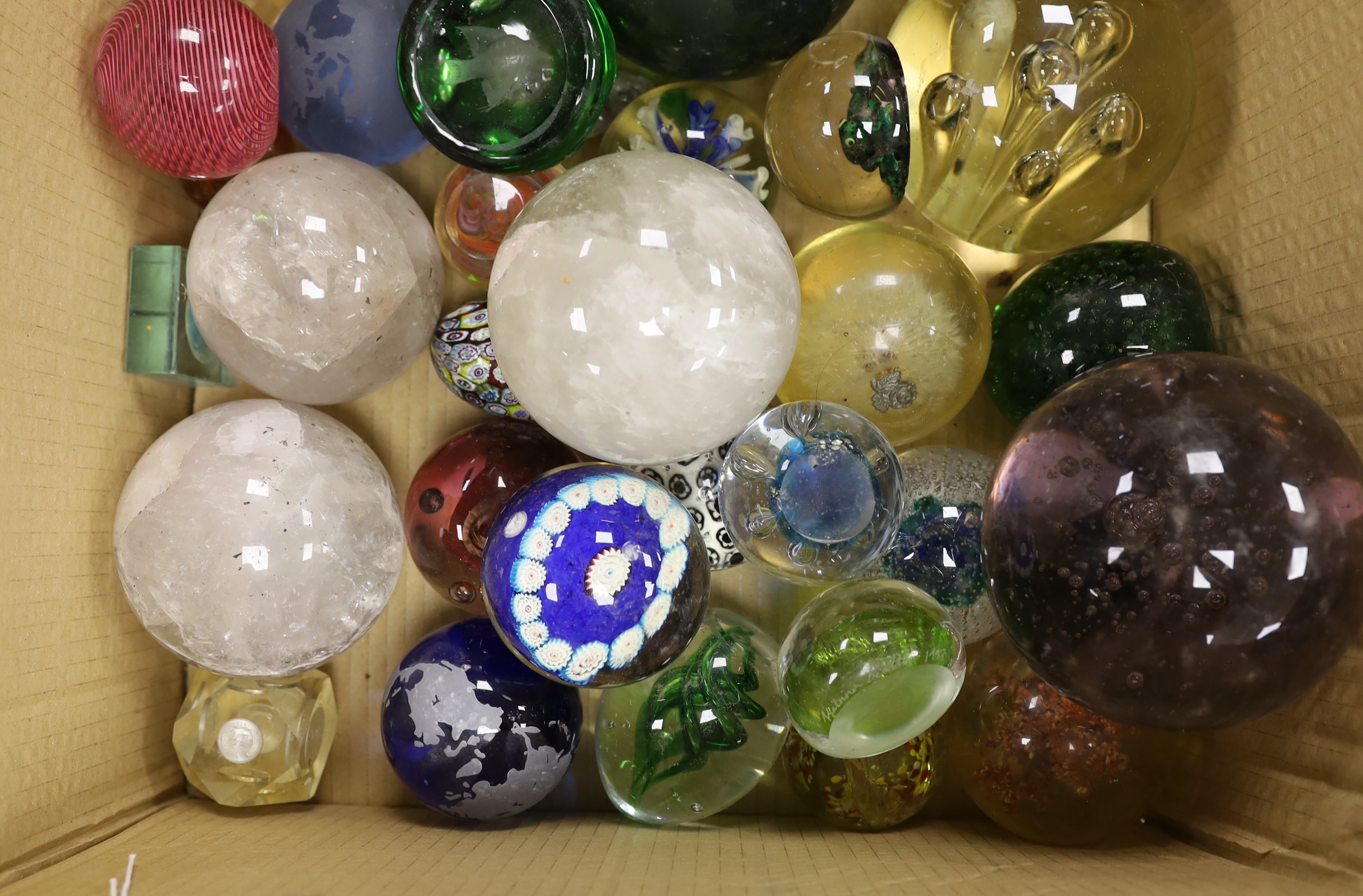 A collection of thirty three mixed glass and stone paperweights and three quartz balls